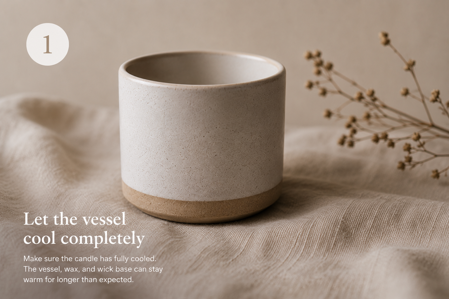 Handmade ceramic candle vessel after the final burn, resting on natural linen fabric